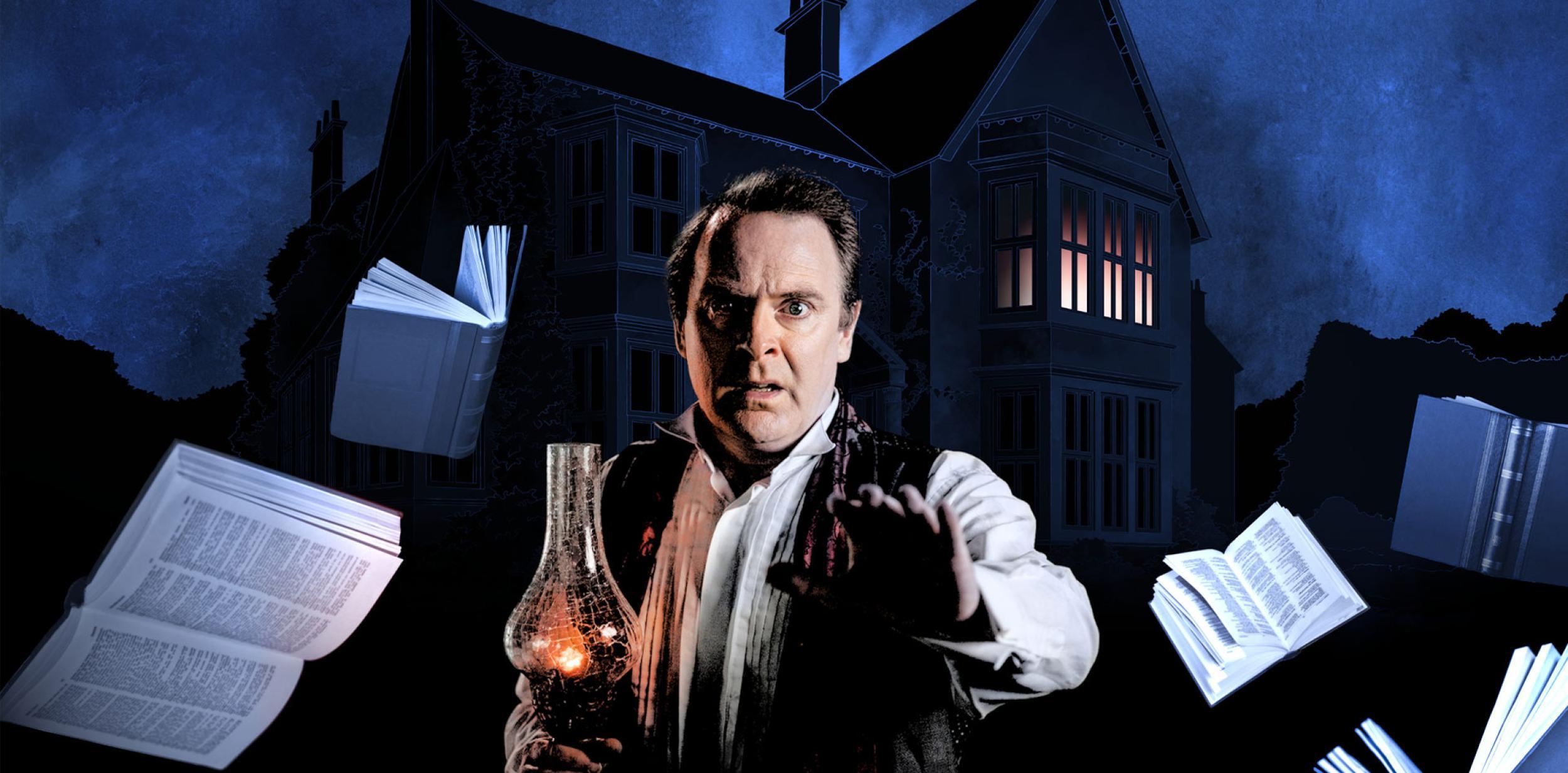 A man holding a lantern outside a spooky house