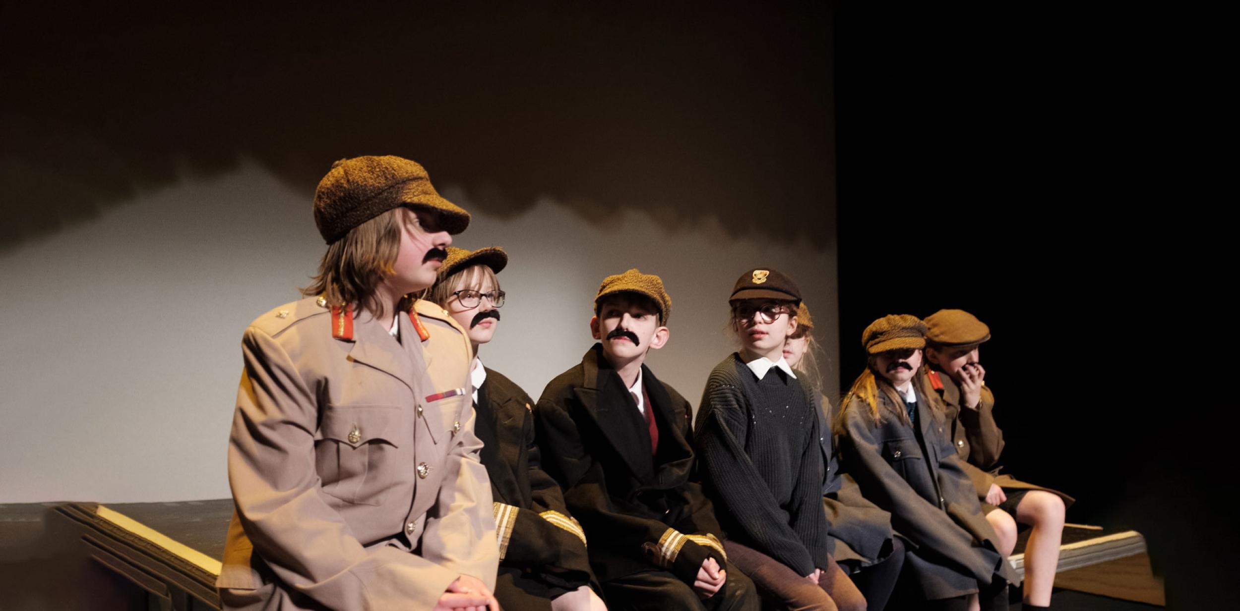 A group of young children in theatre costumes