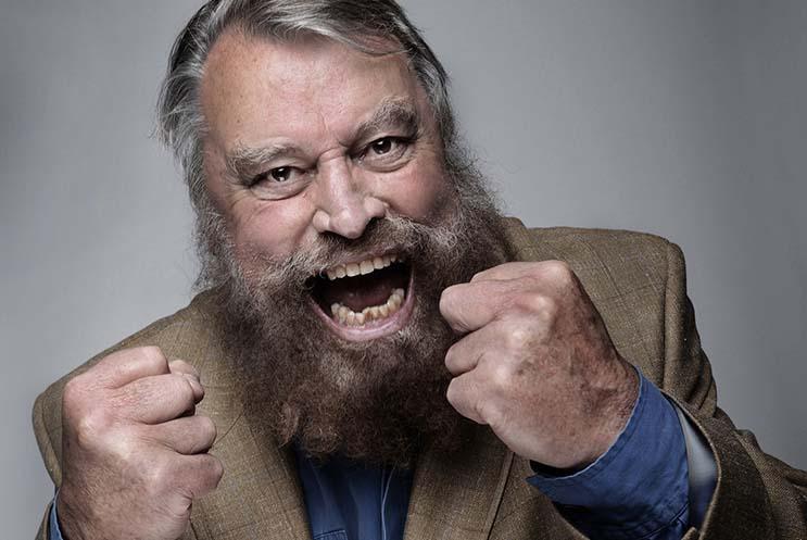 Brian Blessed with full beard and fists clenched