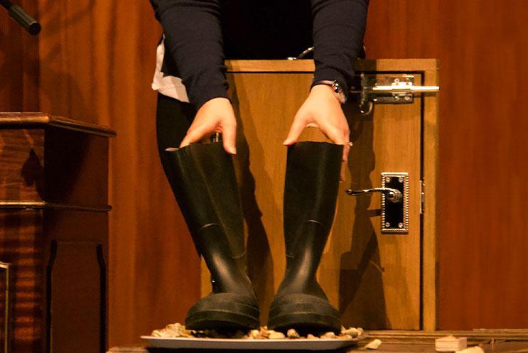 A foley artist using wellies and gravel