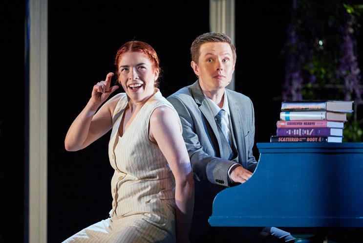 Two actors in front of a piano